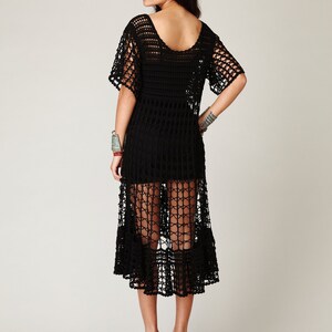Puede incluir: Un vestido maxi de crochet negro de corte holgado y bajo festoneado. El vestido est&aacute; hecho de una tela ligera y transpirable y tiene un estilo relajado y bohemio.
