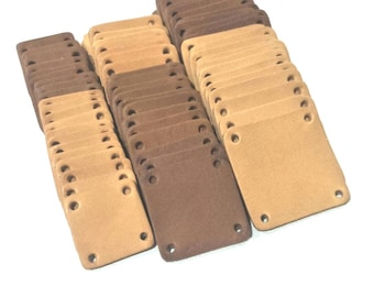 May include: A large stack of brown and beige leather patches with four holes each. The patches are all the same size and shape.