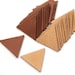 May include: A stack of brown and tan leather triangle shapes. The triangles are arranged in a pyramid shape.