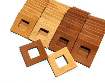 May include: A stack of 25 leather squares with a square hole in the center. The squares are in two shades of brown, a light brown and a darker brown.