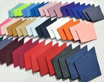 May include: Assortment of leather arrow shapes in various colors, including red, blue, green, pink, orange, and brown.