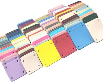 May include: A collection of colorful leather patches with four holes each. The patches are arranged in rows and columns, with the colors ranging from light to dark.