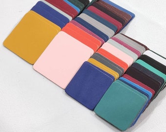 May include: A variety of leather swatches in different colors, including yellow, pink, blue, green, red, and gray. The swatches are arranged in a fan shape, with the yellow swatch at the top and the gray swatch at the bottom.