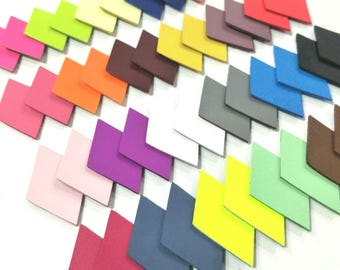 May include: A collection of colorful fabric swatches in various shades of pink, purple, red, orange, yellow, green, blue, brown, gray, and white. The swatches are arranged in a staggered pattern, creating a visually appealing display.