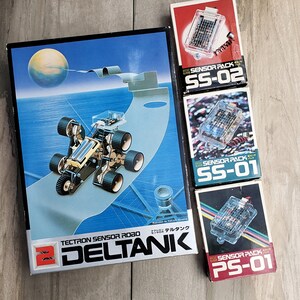 May include: A box for a TECTRON SENSOR ROBO DELTANIK robot toy. The box features a blue and white illustration of the robot on a futuristic landscape. Three smaller boxes are also shown, labelled "SENSOR PACK SS-02", "SENSOR PACK SS-01", and "SENSOR PACK PS-01".