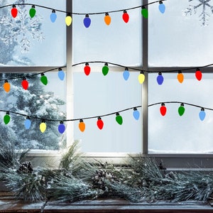 May include: A window with a snowy view outside. A string of colorful Christmas lights is strung across the window. The lights are red, orange, yellow, green, blue, and purple.
