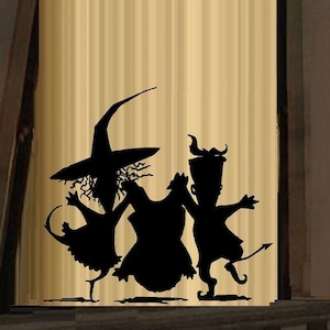 May include: Silhouette of three figures dressed as a witch, a devil, and a ghost, dancing together. The figures are black against a light brown background.