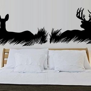 May include: Black silhouette wall decals of a doe and a buck lying down in tall grass. The text "His Doe" and "Her Buck" is included in the design.