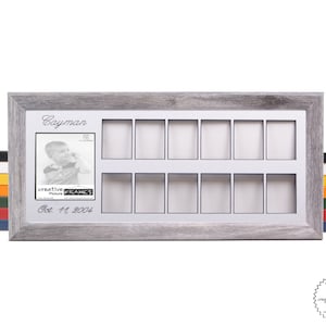 May include: A gray wooden picture frame with a white mat and 12 openings for photos. The frame has the name "Cayman" and the date "Oct. 11, 2004" printed on it.