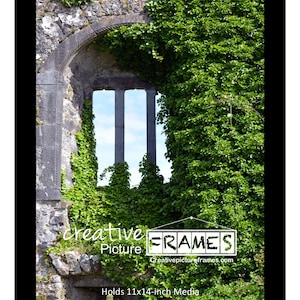 May include: Black picture frame with a stone archway and window opening onto a blue sky. The archway is covered in green ivy. The frame holds 11x14-inch media. The words "creative Picture FRAMES" are in the lower left corner.