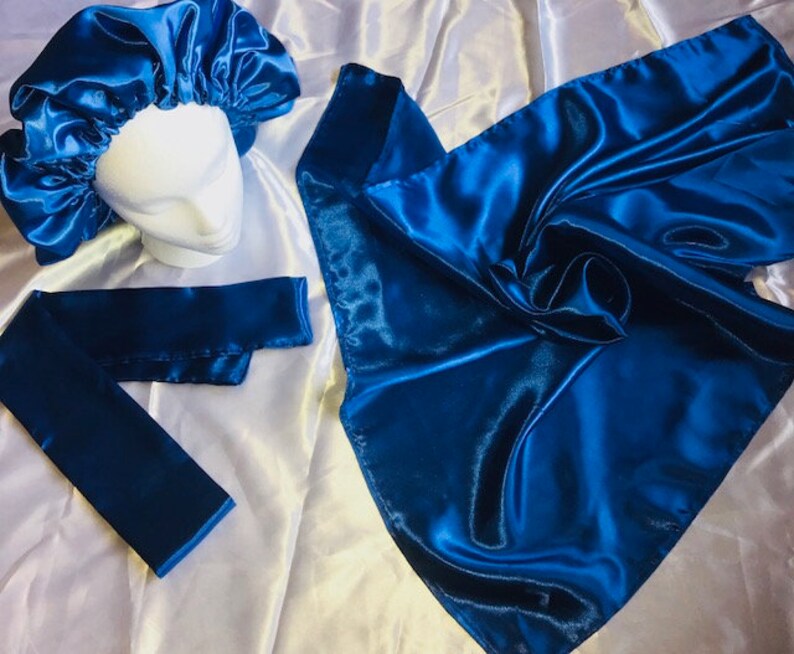 May include: A set of three blue satin hair accessories. The set includes a satin bonnet, a satin scarf, and a satin headband.