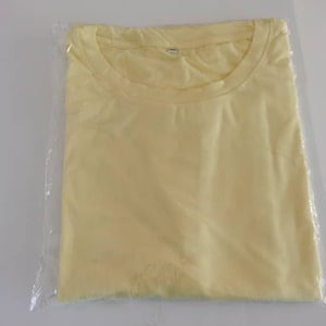 T Shirt 95% polyester 5 spandex. Cottony feel. Stretchy. Please size up.