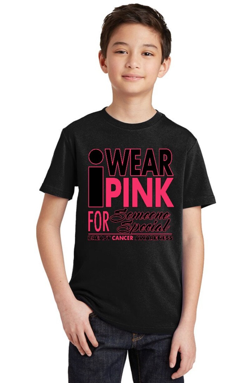 May include: Black t-shirt with pink lettering that reads "I Wear Pink For Someone Special" and "Breast Cancer Awareness".