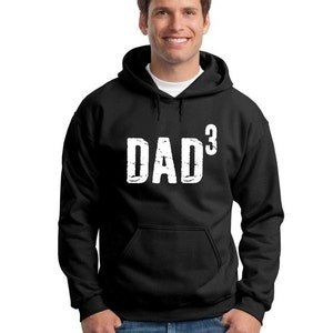 May include: Black hooded sweatshirt with a white graphic that says "DAD³".