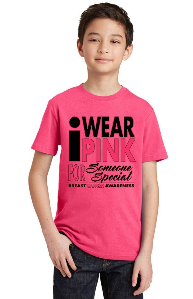 May include: A pink t-shirt with a black graphic that says "I Wear Pink For Someone Special" and "Breast Cancer Awareness".