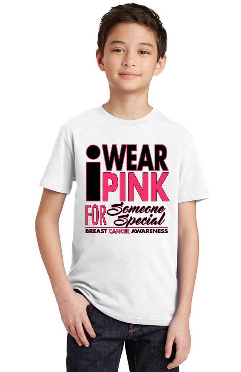 May include: White t-shirt with a pink and black graphic that says "I Wear Pink For Someone Special" and "Breast Cancer Awareness".