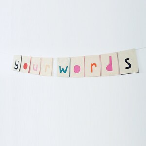 May include: A banner with the words "your words" in colorful letters on a white background.