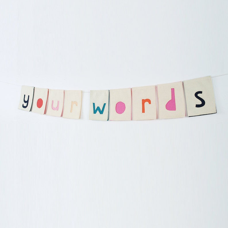 May include: A banner with the words "your words" in colorful letters on a white background.