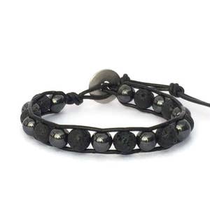 May include: Black leather bracelet with black lava rock and hematite beads. The bracelet has a silver clasp.