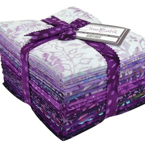 May include: A stack of 20 fat quarters in shades of purple, tied with a matching ribbon and bow. The fabric features floral and abstract patterns. A tag reads "Java Batik".