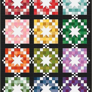 May include: A patchwork quilt featuring a grid of colorful starburst patterns. Each star is composed of small squares in shades of red, pink, yellow, green, orange, blue, and purple. The quilt has a black border with checkered accents.