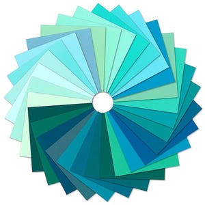 May include: A collection of square paper sheets arranged in a circular fan pattern, showcasing a gradient of colors ranging from pale mint and light sky blue to deep teal, dark turquoise, and rich ocean blue shades, all centered around a white hole.