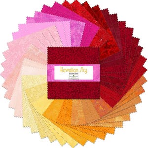 May include: A circular arrangement of fabric squares in shades of red, pink, and yellow. A central stack of red fabric squares is wrapped with a label that reads "Hawaiian Sky". The fabric squares are likely for quilting or other craft projects.