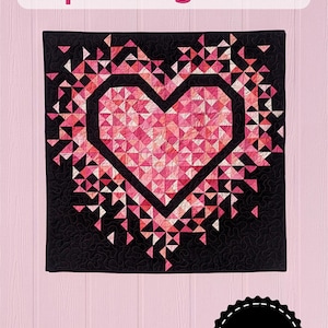 May include: Mini Exploding Heart quilt pattern by Slice of Pi Quilts. A pink and white heart explodes with smaller triangles on a black background.