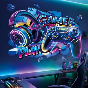 May include: A wall decal featuring a neon-style graphic of gaming headphones and a game controller. The design includes the text GAMER and PLAY, set against a background of blue, purple, and yellow light effects with a 3D-style cracked wall effect.