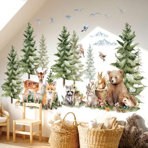 May include: A watercolour wall decal depicting a forest scene with a deer, fox, raccoon, rabbit, squirrel, bear, and hedgehog. The design includes evergreen trees, birds, and mountains, creating a whimsical woodland theme.
