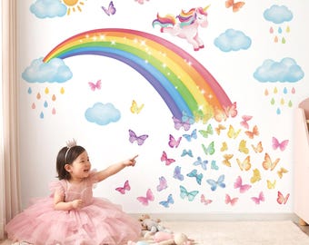 May include: A wall decal set featuring a colorful rainbow, a white unicorn with a multicolored mane, a yellow sun, blue clouds with colorful raindrops, and numerous butterflies in various shades of pink, blue, yellow, and purple.