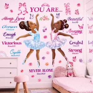 May include: A wall decal set featuring two Black ballerinas in blue and pink tutus, surrounded by butterflies, roses, and ballet slippers. The text reads: YOU ARE... Always Loved, Chosen, Enough, Victorious, Capable, Beautiful, Amazing, Created, Strong, NEVER ALONE, and various Bible verses.