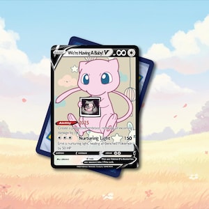 May include: A custom trading card featuring a pink Mew character holding a black and white ultrasound image. The card is titled We're Having A Baby! V and includes game text, an ability, and a 150 HP value, set against a soft, illustrated background.