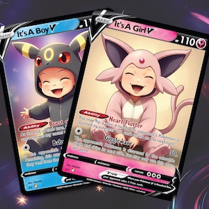 May include: Two Pokemon trading cards featuring a baby Eevee in a pink and a black outfit. The cards are titled "It's A Girl V" and "It's A Boy V". The cards have a light blue and pink background with black borders.