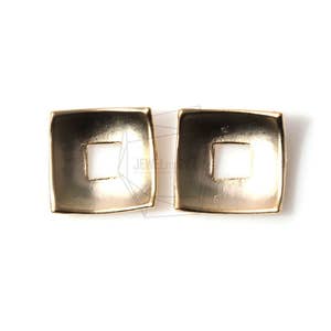 May include: A pair of gold-toned square earrings with a square cutout in the center. The earrings have a slightly rounded edge.