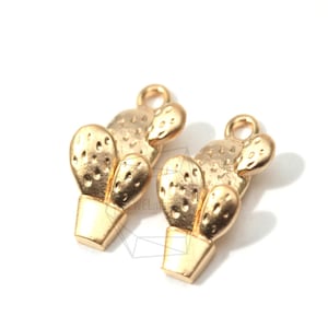 May include: Two gold-tone cactus charms with a textured surface. Each charm has a small loop at the top for attaching to jewellery or other crafts.