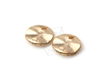 May include: Two gold-toned metal round disc charms with a small hole in the center. The discs have a hammered texture.