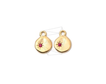 May include: Two gold-toned metal charms with a small red star-shaped gemstone in the center of each charm.