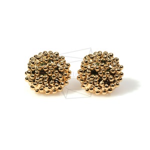 May include: A pair of gold-toned stud earrings with a textured, spherical design. Each earring is made up of many small, round beads.