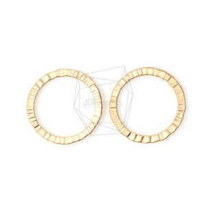 May include: Two gold-colored metal rings with a textured, wavy edge. The rings are round and have a smooth inner surface.