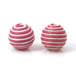 May include: Two pink and white striped round balls made of woven rope.