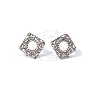 May include: A pair of silver earrings with a square shape and a circle design in the center.