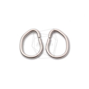 May include: Two silver jump rings, each shaped like an oval, are shown against a white background.
