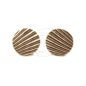 May include: A pair of gold-toned earrings with a textured, circular design. The earrings have a ridged, radial pattern.