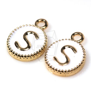 May include: Two gold-tone charms with a white enamel background and a gold-tone letter "S" in the center. Each charm has a small loop at the top for attaching to a necklace or bracelet.