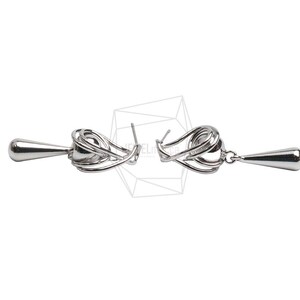 May include: A pair of silver-colored drop earrings. Each earring features a looped design with a teardrop-shaped pendant. The earrings are displayed against a white background, highlighting their intricate details and reflective surface.