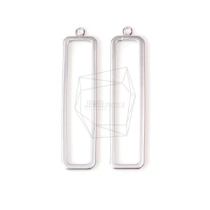 May include: Two silver-colored rectangular pendant blanks with a small loop at the top for attaching to a chain or other jewelry component. The pendants are empty inside and have a simple, modern design. The background is plain white.