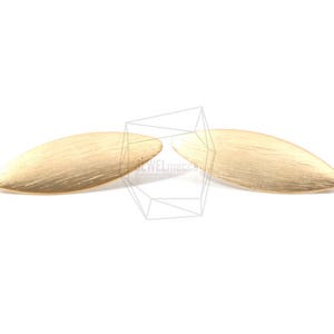 May include: A pair of gold-toned earrings in the shape of a leaf. The earrings have a brushed finish.