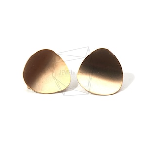 May include: A pair of gold-toned earrings with a rounded, slightly asymmetrical shape. The earrings have a gradient effect, with a lighter shade of gold at the top and a darker shade at the bottom.