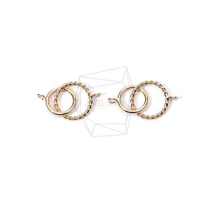 May include: Two gold-toned metal clasps with a twisted rope design. Each clasp has a circular shape with a smaller circle inside.